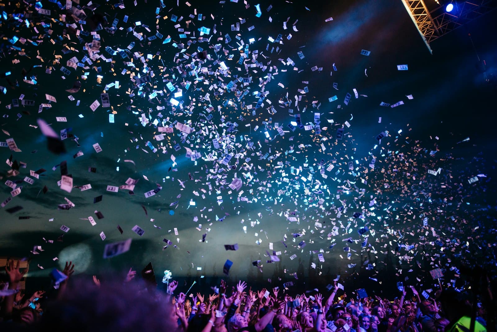 Concert crowd under stage lights as doors open